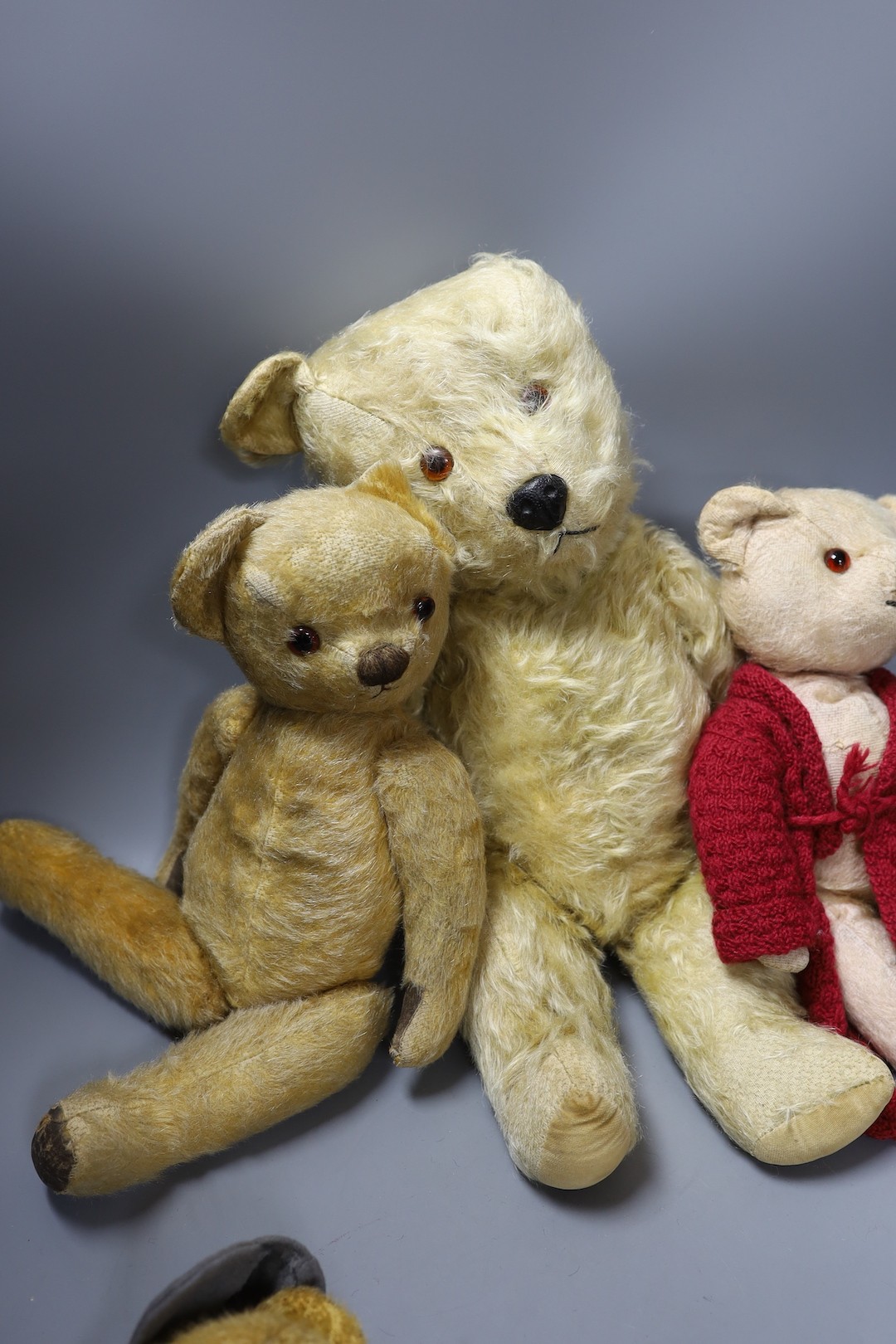 Chiltern Hugmee 1960's, 53cm, a Chadvalley 1950's, 43cm, also a Chadvalley, red gown, 35cm, and an English bear dressed as a schoolboy, 35cm.